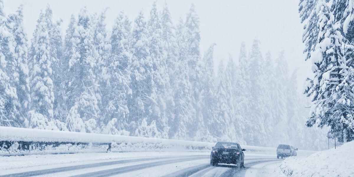 vehicle on road in winter snowfall